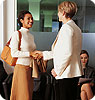 A woman shaking hands with another woman.