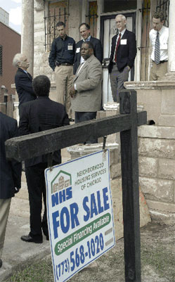 The tour stops to view a property renovated by the Neighborhood Housing Services of Chicago.