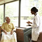 Doctor at hospital speaking to patient in wheelchair