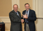 a photo of Toni Scarpa and David Sahn holding an award.