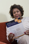 a photo of an African-American woman reading a brochure.