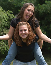 Image of a couple girls piggy back riding