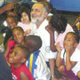 Photo of President of the Iranian Table Tennis Team surrounded by youth at the Andre Agassi Boys and Girls Club