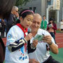 Photo of A Da Yi student reading a letter she wrote to American Public Diplomacy Envoy Cal Ripken