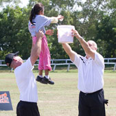 Photo of Cal Ripken receiving a baseball – up high – from a Nicaraguan participant during cleanup