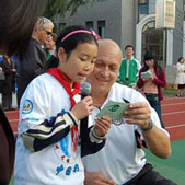 Photo of a Da Yi student reading a letter she wrote to American Public Diplomacy Envoy Cal Ripken 