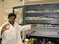 Photo of Sudipta Seal holding a bottle containing billions of ultra-small, engineered nanoceria.