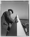 Horydczak examining top of Washington Monument