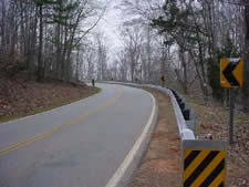 W - Beam Guardrail and end treatment installed on the outside of a horizontal curve.