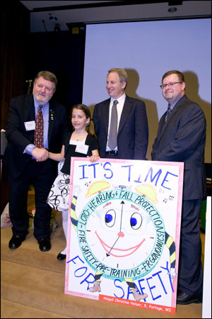 (L to R) Warren Brown, President, ASSE; Abigail Helser, ASSE Safety-on-the-Job poster contest winner (Age 7-8 Age Group Category); Jordan Barab, Acting Assistant Secretary, OSHA; and Andrew Cooper, Secretary, CSSE, at the 2009 NAOSH Week Kick-off event on May 4, 2009 in Washington, DC.