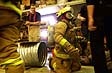 Firefighters at McMurdo Station demonstrate firefighting techniques to the McMurdo community during a 2002 expo.