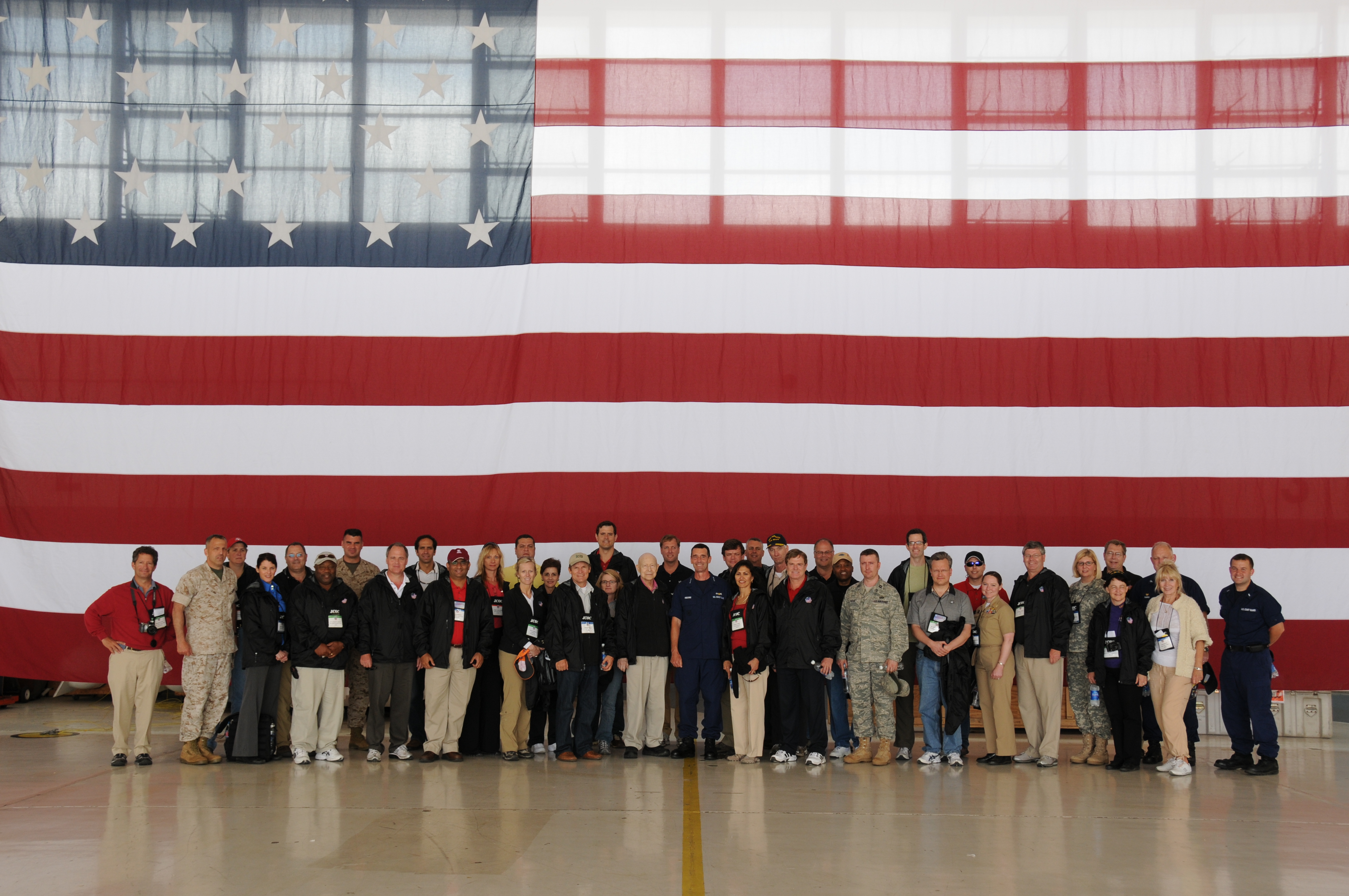 Members of JCOC77 pose for a picture with Vice Admiral David Pekoske, Pacific Area Commander, in a Coast Guard hanger in San Diego, CA.