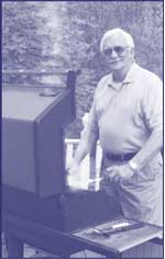 photo of a man cooking on an outdoor barbeque