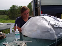 A scientists collecting ground-water samples anaerobically in a glove bag