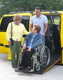 photo of woman exiting taxi on ramp.