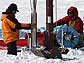 two people drilling ice cores