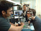 Professor James Fujimoto, center, with students using the eye-imaging technique he began developing in the early 1990s. With his head in the apparatus is Desmond C. Adler and at left, taking measurements, is Vivek Srinivasan. Adler and Sriinivasan are both graduate students in electrical engineering and computer science