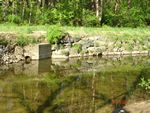 Location 8 - Concrete thrust block with 18-in. clogged culvert at downstream end of rock embankment