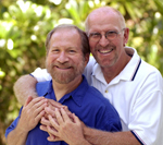 Image of older male couple embracing.