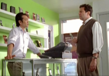 Image from 30-second video showing male customer in phone store talking to salesman.