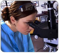 Girl looking through a microscope