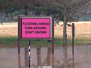 NOAA illustration of flooding safety awareness road sign.