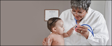 Photo: An infant with a healthcare professional