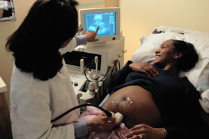 A picture of a pregnant woman getting an ultrasound