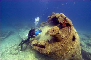 diver investigating underwater wreck
