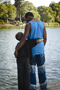 adult hugging child in lake