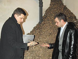 East Europe Foundation Executive Director Victor Liakh (left) and Voznesensk Agency for Economic Development Project Director Sergei Averkov examine wood chips, part of the city’s energy efficiency initiative - Photo Credit:	Simone Kozhukharov