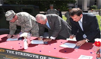 Governor Gibbons, Lt. Governor Krolicki, and Nevada National Guard Adjutant General William Burks sign the Military Community Covenant during a ceremony on the Capitol Grounds on Tuesday, August 18.