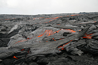 In this close-up view of the breakout at the top of Royal Gardens, a vigorous lobe of pāhoehoe - fed by a small channel upstream - advances over older flows. 