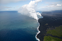The Waikupanaha and Kupapa`u ocean entries continue to produce moderate to large steam plumes. The county viewing area is visible between the groups of trees in the lower right corner of the photograph.