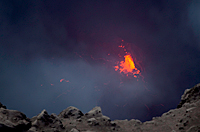 View of the lava surface within the Halema`uma`u cavity showing a crusted lava surface with spattering from a single source along the northeast margin.