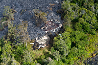 In this close-up of the burned structure, notice how the metal roofing is on top of the lava. The lava had apparently flowed through this part of the building, which was probably a garage, before the framing completely burned and the roof collapsed. 