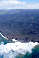 Despite the slow-down in activity this morning, lava continues to enter the ocean at Waikupanaha where a small, unstable delta clings to the sea cliff. Fume and white staining at least partly traces the tube system upslope to the Royal Gardens subdivision on the slope in the upper left-hand side of the photo. Fume from the TEB vent is on the skyline just above the pali, and Pu`u `Ō `ō is the small cone on the skyline on the left edge of the photo.