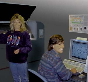 A color photograph showing two women operating a scanner and a computer.