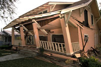 A color photograph of a house that is partly falling down.