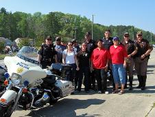 Karen Steele (white shirt) with the Suffolk Police escort team for the Suffolk Crime Line's fourth annual 'Bikers Against Crime.'