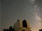 Photo of the summer Milky Way behind the Hale Telescope at the Palomar Observatory.