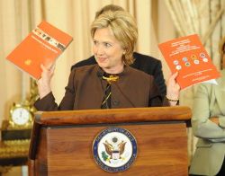 Date: 06/16/2009 Description: Secretary Clinton holds copies of the 2009 Trafficking in Persons Report and the Attorney General's Annual Report to Congress and Assessment of U.S. Government Activities to Combat Trafficking in Persons as she gives remarks at the release of the report. © State Dept Image