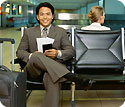 A man sitting at a bench in the airport.