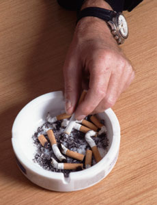 A hand putting out a cigeratte in an ash tray
