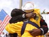 Naval Station Norfolk, Va., Mar. 27, 2002 — A Navy Storekeeper embraces a loved one following the arrival of the USS Theodore Roosevelt (CVN 71) carrier battle group (CVBG) at the Naval Station, Norfolk, Va. Theodore Roosevelt departed Norfolk on September 19, 2001, to join the fight against terror. She completed a record 159 consecutive days at sea during the 189 days she was deployed in support of Operation Enduring Freedom. The carrier also covered some 60,000 miles. The homecoming of more than 7,000 Sailors and Marines was documented on national television networks this morning. U.S. Navy photo by Photographer's Mate 1st Class Tina M. Ackerman. [020327-N-1110A-501] Mar. 27, 2002