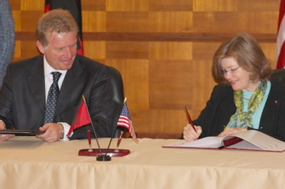 A man and woman sign documents