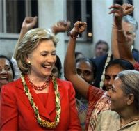 Date: 07/18/2009 Description: U.S. Secretary of State Hillary Rodham Clinton, center, smiles as she interacts with members of Self Employed Women's Association, a non-government organization, in Mumbai, India, Saturday, July 18, 2009.  © AP Image