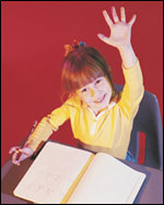 Photo: A student raising her hand.