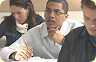 One female and two male students taking a test.