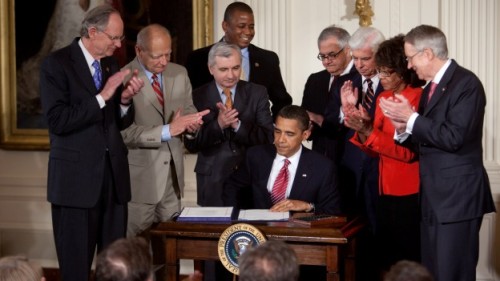 President Obama signing the Helping Families Save Their Homes Act